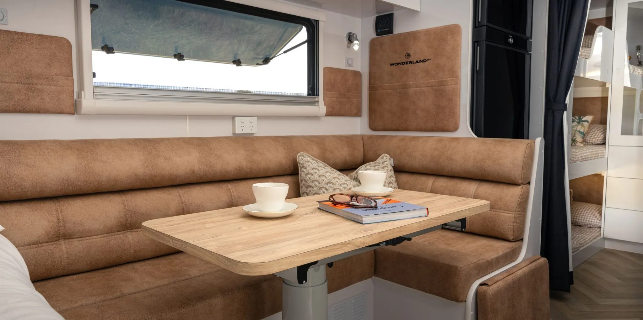 Tan leather dinette set for coffee inside a Wonderland RV