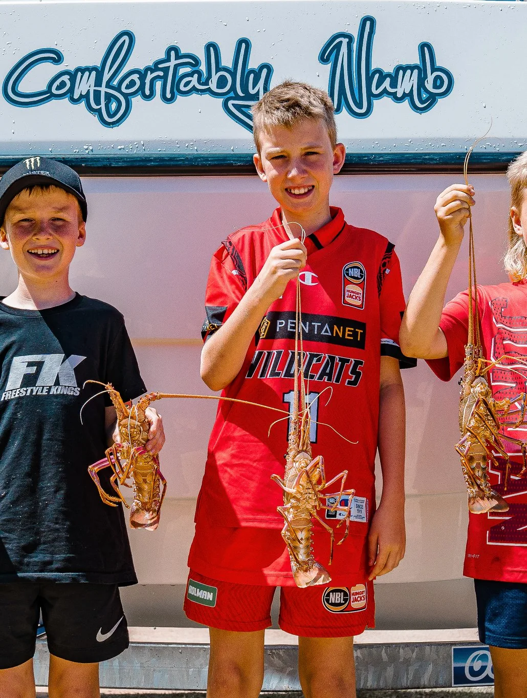 Jye and Cruz of the Wheatland Wanderers holding crayfish