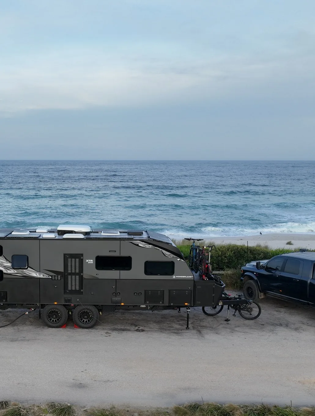 Livin In Sanity&rsquo;s XTR and tow vehicle parked above the ocean