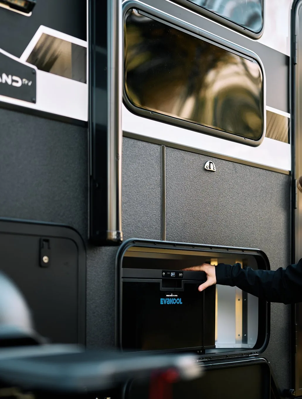 Opening an external storage hatch on the Sandy Van Travels caravan