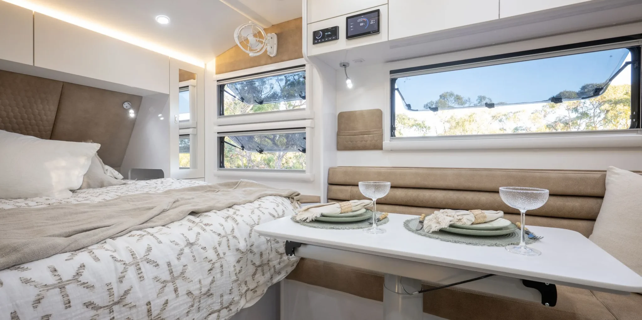 Queen bed and dinette inside a Wonderland RV