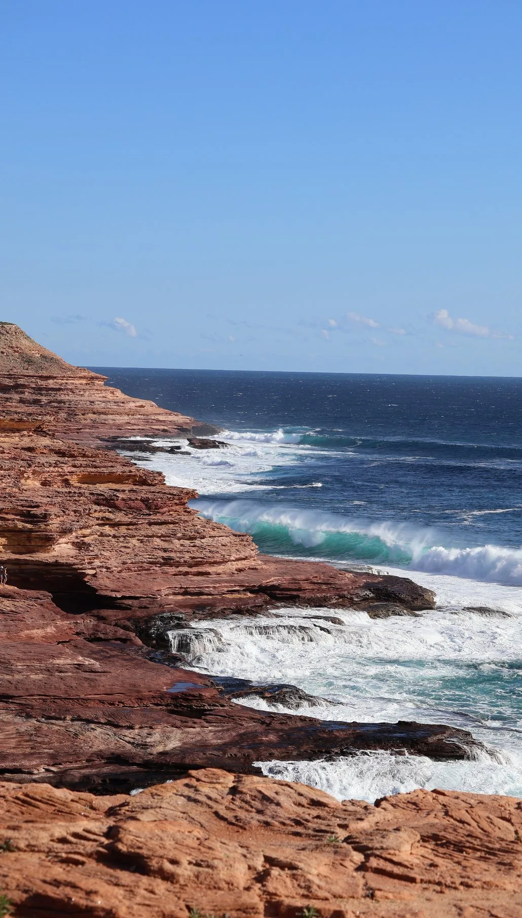 Red cliffs and surf on the coast