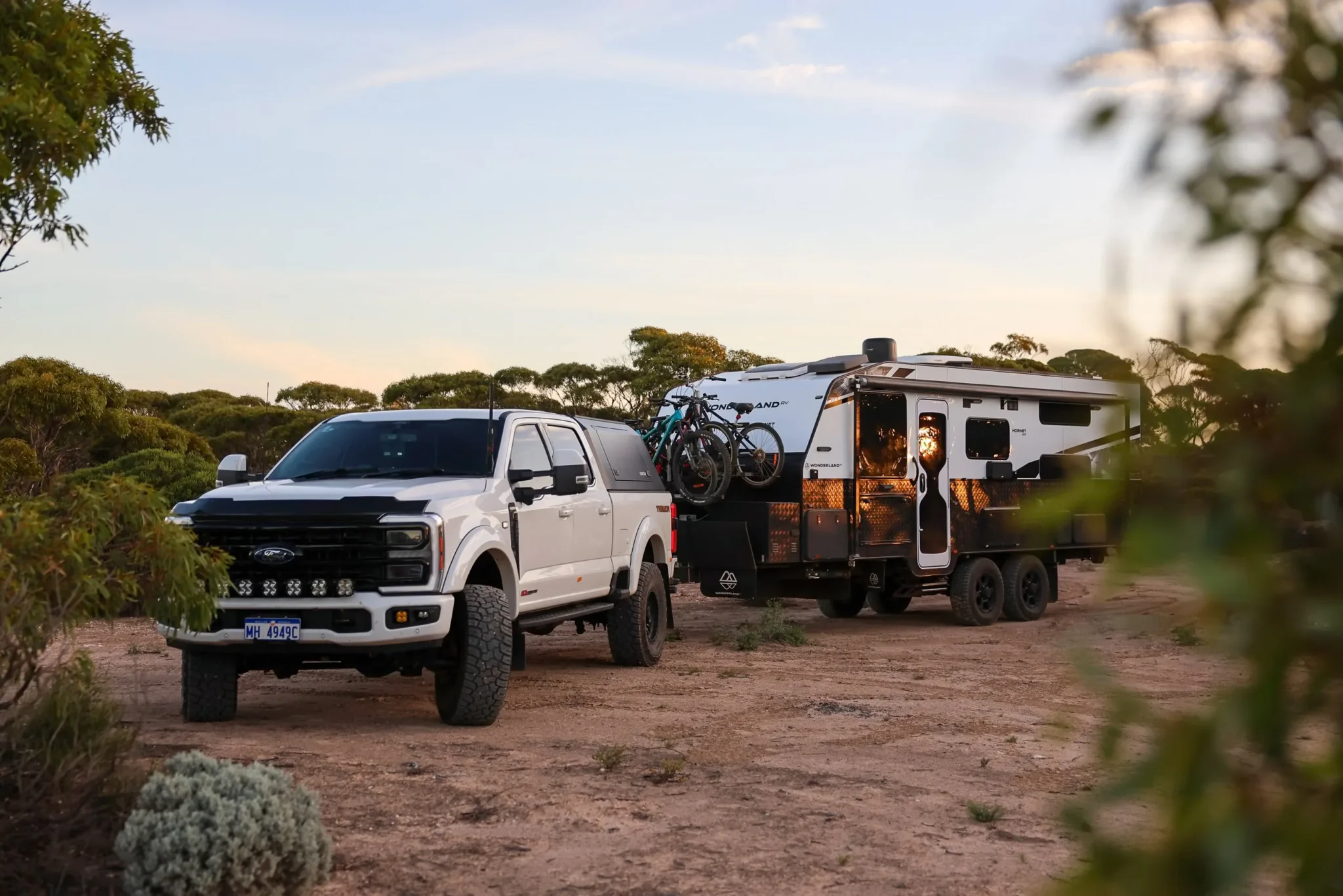 The Kiwi Van Life&rsquo;s Wonderland RV Hornet and F350 at camp at golden hour