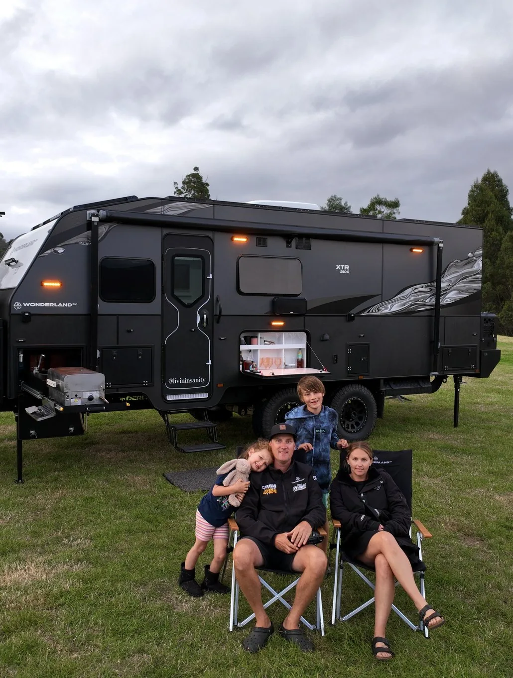 The Livin In Sanity family relaxing at camp beside their XTR